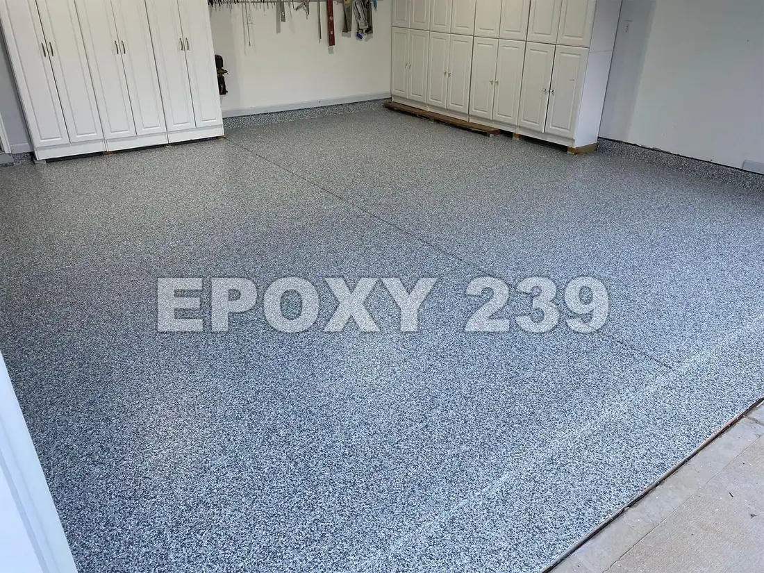 Garage with white cabinets and a Stargazer flake epoxy floor